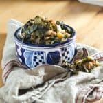 Slow cooked souther collard greens are made with love... and bacon! Fresh garlic and chicken stock take this recipe back home.