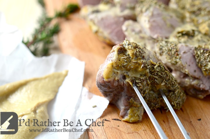 A baked pork tenderloin recipe with melt-in-your-mouth herb dijon crust and juicy pork!