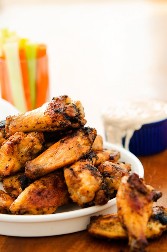 This crispy baked chicken wings recipe uses a dry rub for flavor and blue cheese sauce to kick it up!