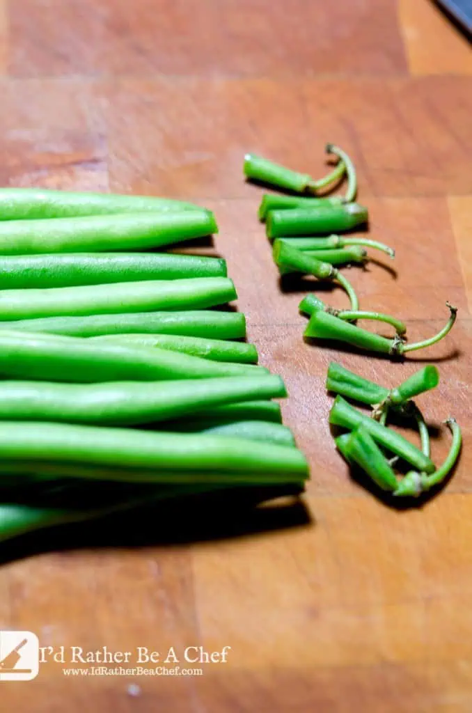 Trimming the beans for this haricot vert recipe is really easy. Simply line up the haricot vert and slice off the stems. These green beans are ready to cook!
