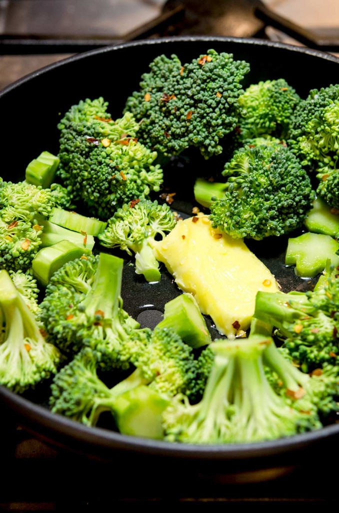 To prepare this Italian Broccoli Recipe, first add all the ingredients into the pan, including the red pepper flakes, garlic, butter and water.