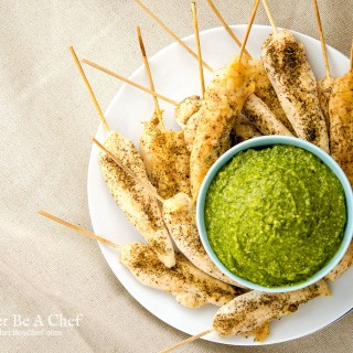 Oven baked chicken tenders with a pesto dipping sauce. Perfect for a party or an afternoon chillin and watching Netflix. This is a fast, easy baked chicken tenderloin recipe.