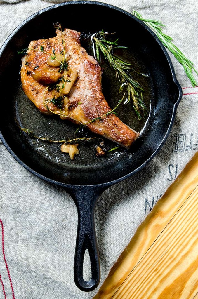 Simple pan seared pork chops with thyme, rosemary and roasted garlic. Perfect, every time.