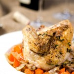 roasted chicken served on top of a bowl of vegetables and topped with herbs