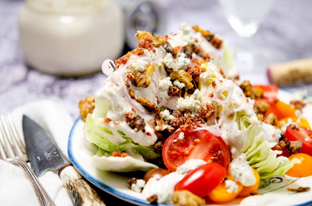 This is the ultimate iceberg wedge salad with homemade blue cheese dressing, crumbly bacon bits, brown butter walnuts, shallots and more...