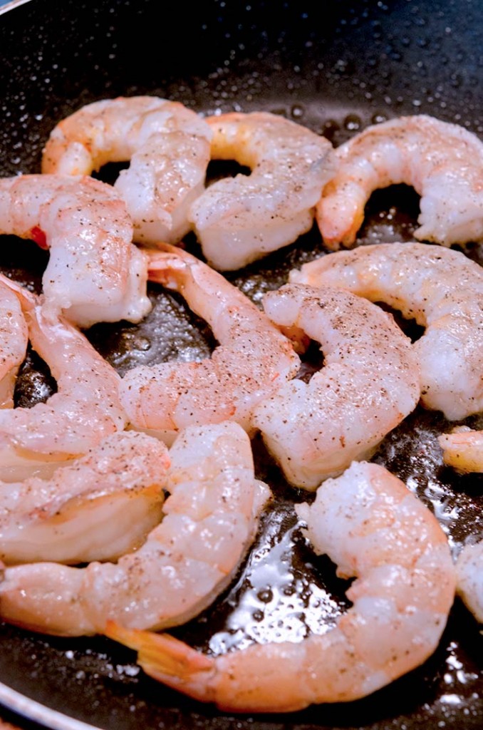 Cook the shrimp over high heat. When they begin to curl and change color, they are ready to flip. Mmm... Shrimp creole here we come!