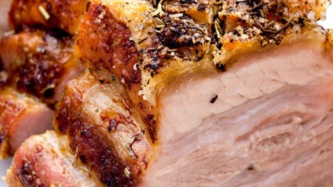 The sixth step for this crispy pork belly recipe is to add herbs de provence, baste and let cook for another hour.
