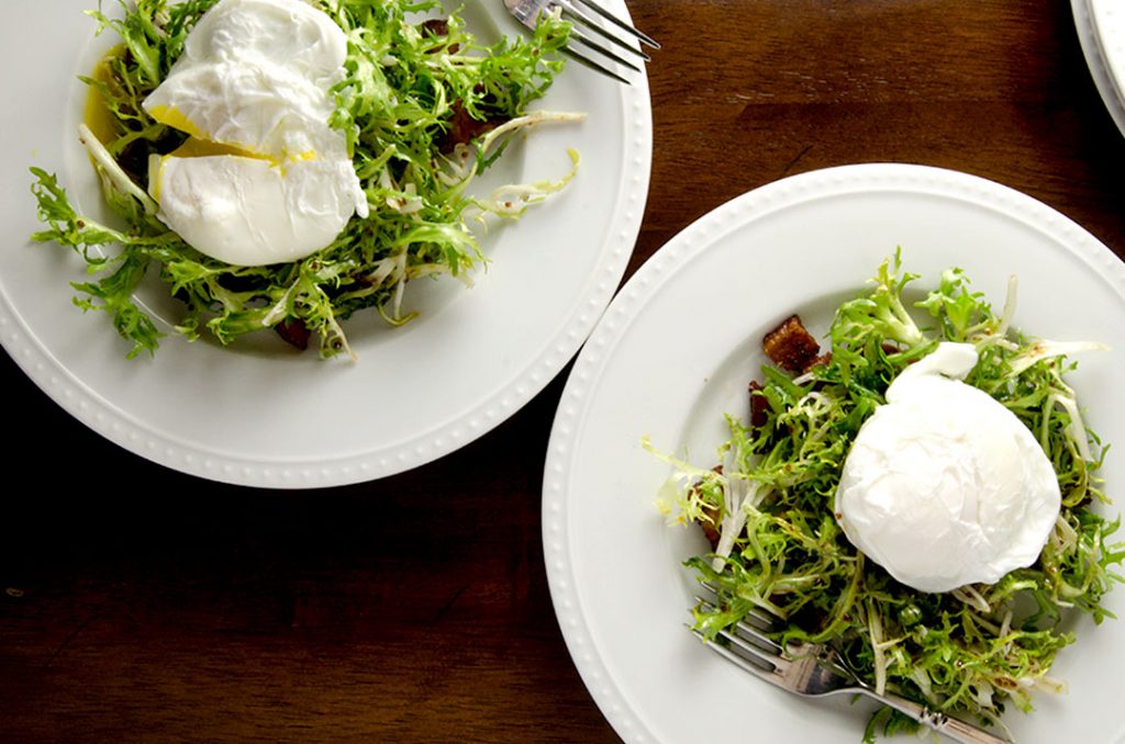 The perfect frisee salad, with bacon fat dressing, bacon croutons and a delightfully runny poached egg.