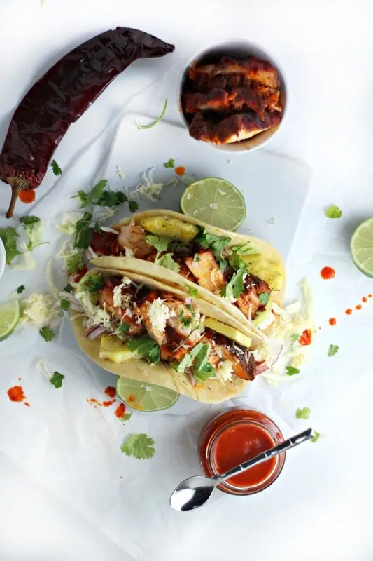 These are drool worthy spoked pork belly tacos. Super delicious and part of our pork belly recipes roundup.