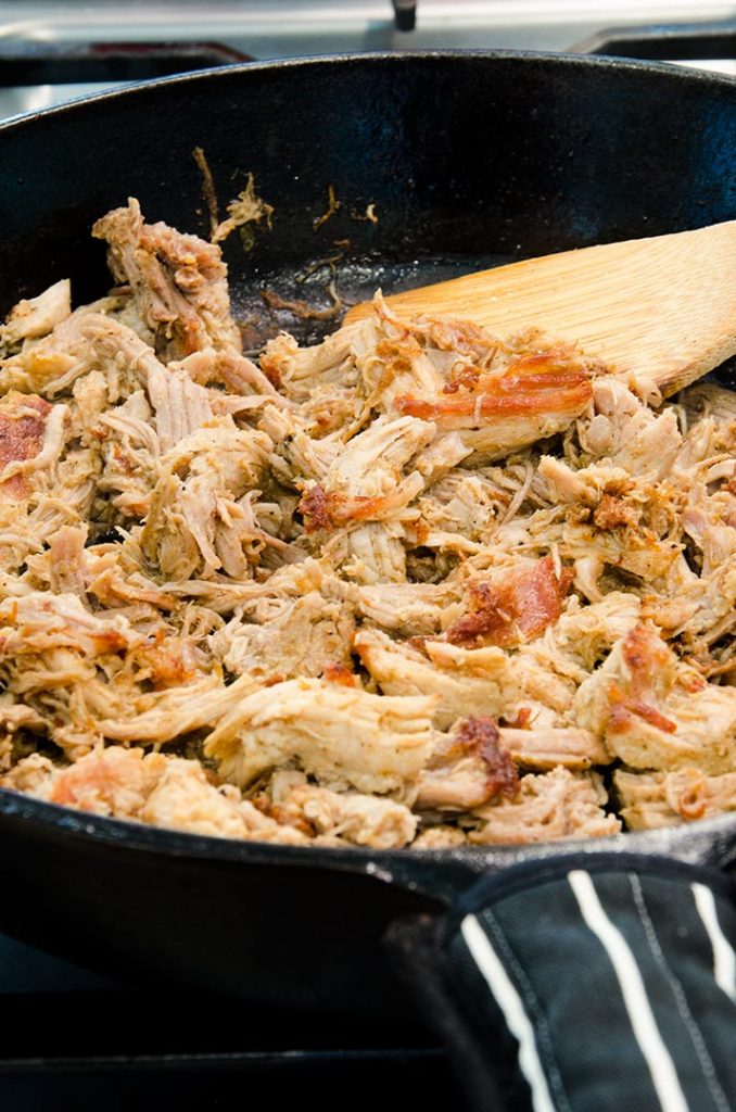 Searing pulled pork intensifies the flavor for our fajita nacho recipe.