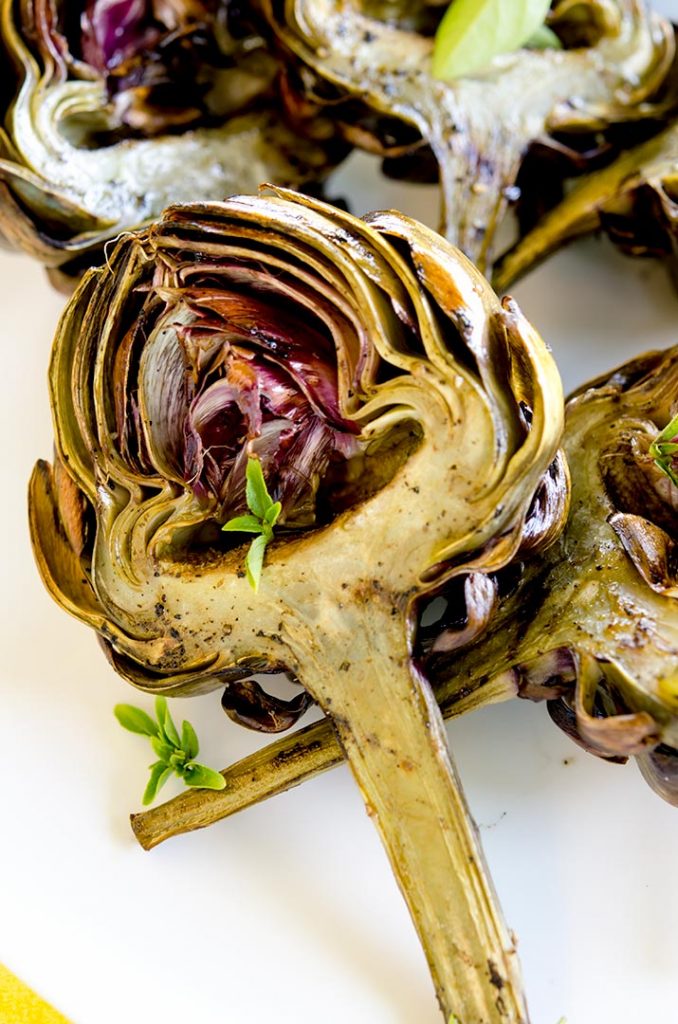 The end result of all the cleaning, steaming and grilling is a tender, juicy and delicious grilled artichoke. So damn good. I hope you enjoy.