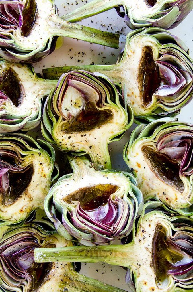Grilled artichokes are best when they are seasoned simply. These have olive oil, red wine vinegar, salt and pepper. Delicious and simple.