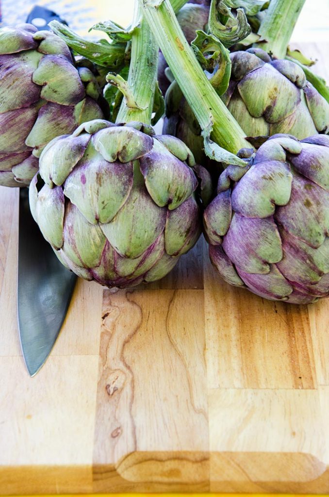 Grilled artichokes are best with the baby version which are purple and green with tender leaves and a sweet heart.