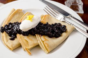 A delicious gluten free crepe topped with blueberry compote and vanilla maple whipped cream. A true breakfast delight.