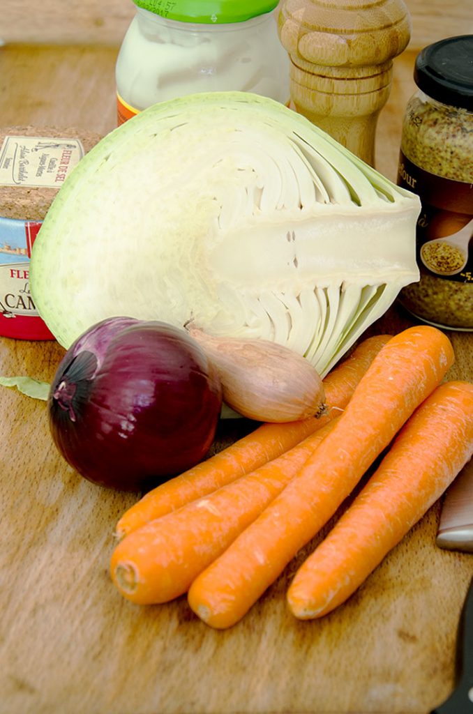 To make this coleslaw recipe you need cabbage, carrots, red onion and a few other pantry ingredients.