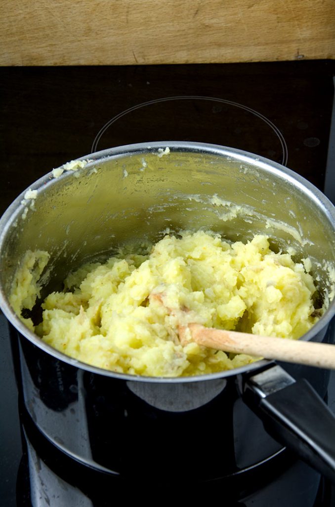 When making smashed potatoes is easy with a wooden spoon, some olive oil and spices.