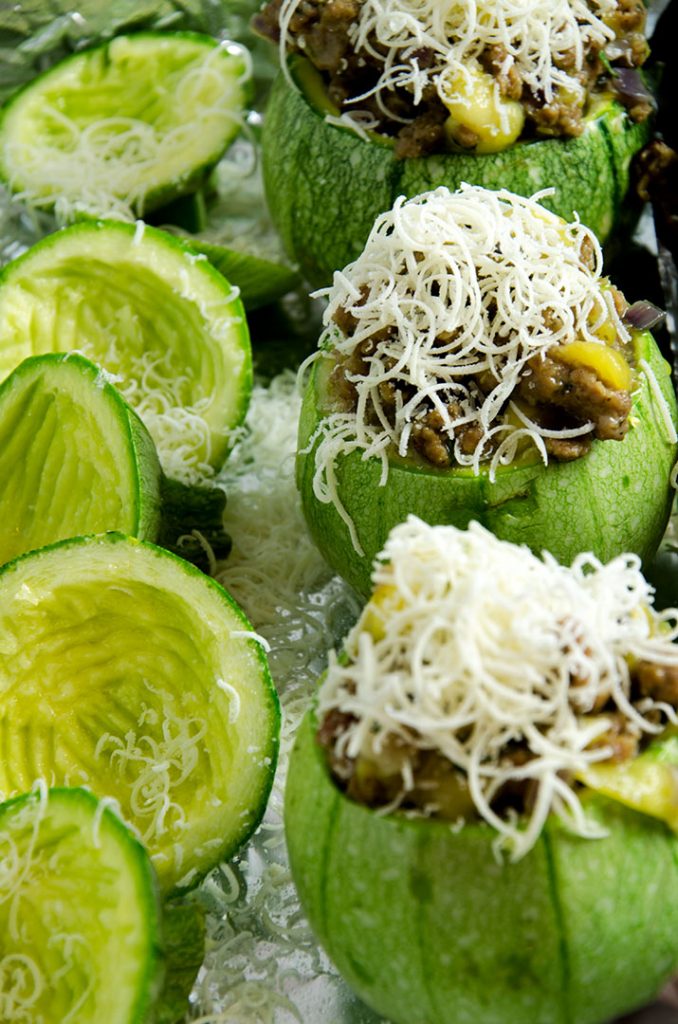 The secret to stuffed zucchini is to fill them ¾ full with stuffing, then pour the egg over and layer more stuffing on top. Yummy.