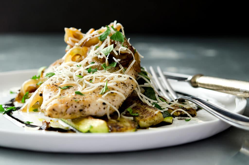 A fantastic sauteed chicken breast that is juicy, tender and delicious. Smother it with onions, shallots, garlic and place it atop a bed of sauteed zucchini... perfection on a plate.