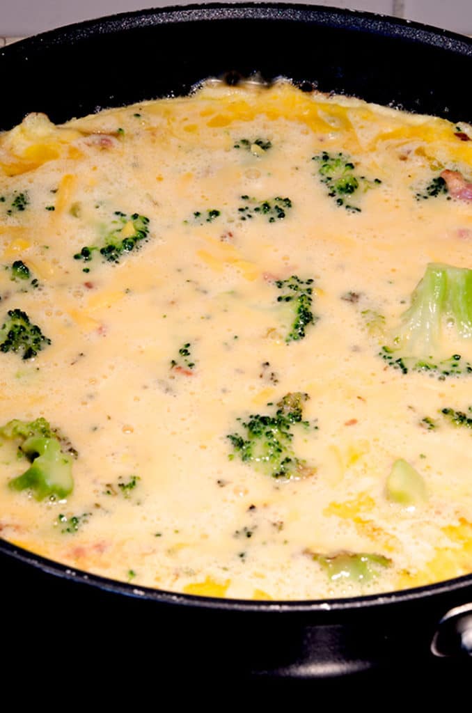 To get a nice crust on an egg frittata, coat the pan with butter, add the egg mixture and cook over high heat until the butter bubbles around the edges. Then add to the oven.