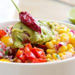 This southwestern salad is a big hit with guacamole, salsa, peppers, onions, a corn relish and chipotle salad dressing.