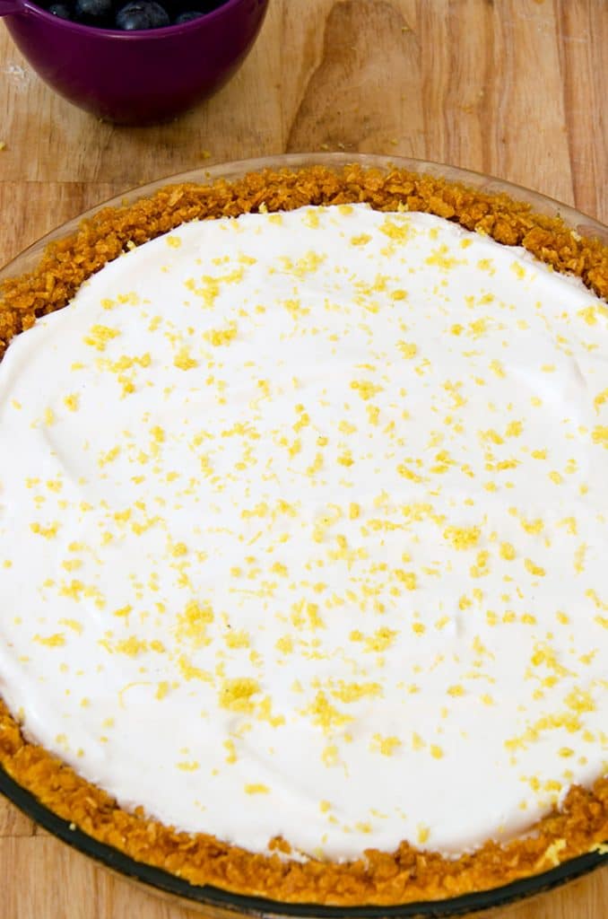 This no bake cheesecake has a layer of whipped cheesecake filling and a thin layer of vanilla whipped cream with lemon zest. Delicious.