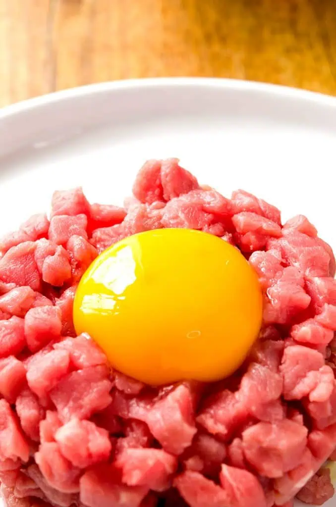 Steak tartare should be made with a raw egg and lots of flavorful toppings!