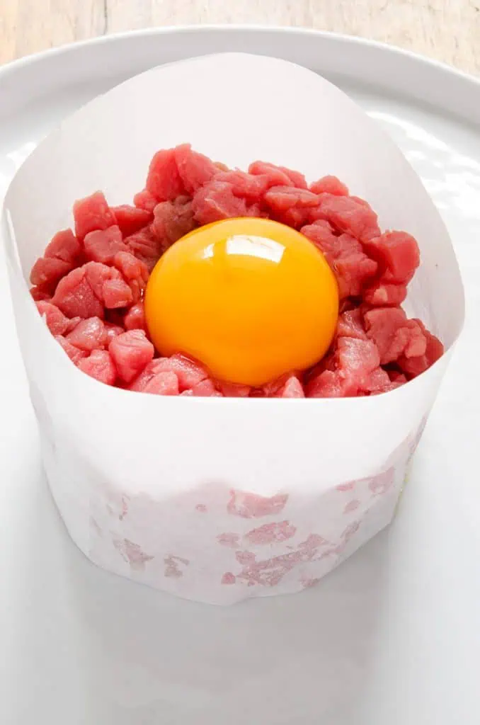 Presentation is important with a steak tartare recipe. Use a paper ring mould if you don't have a metal one.