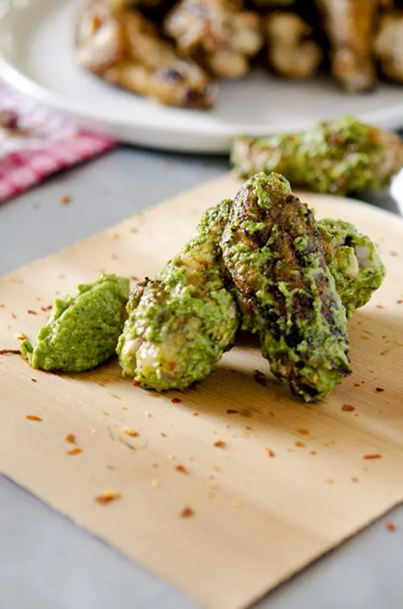 Pesto chicken wings are delicious with red pepper flakes.