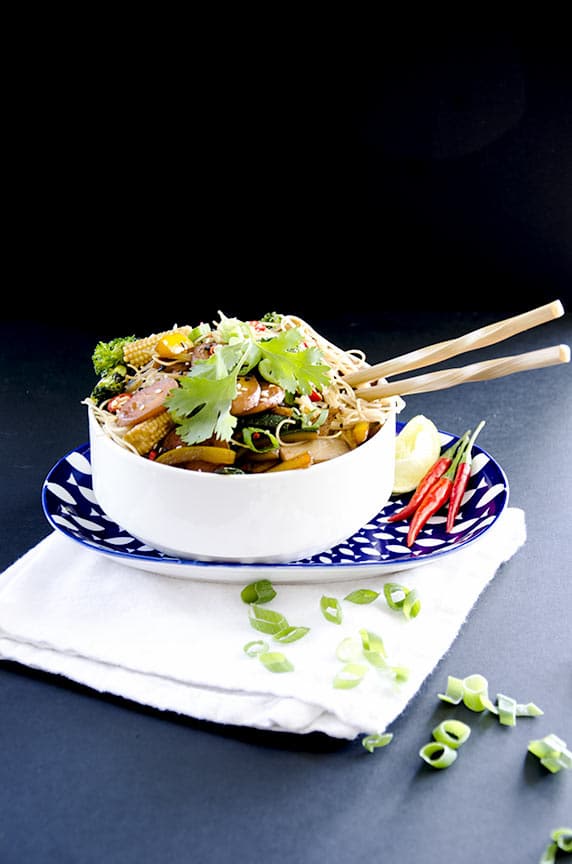 My stir fry noodles recipe is topped with sesame seeds, cilantro, scallion and spicy peppers.