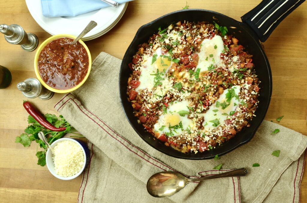 chorizo and eggs overhead shot with skillet and salsa