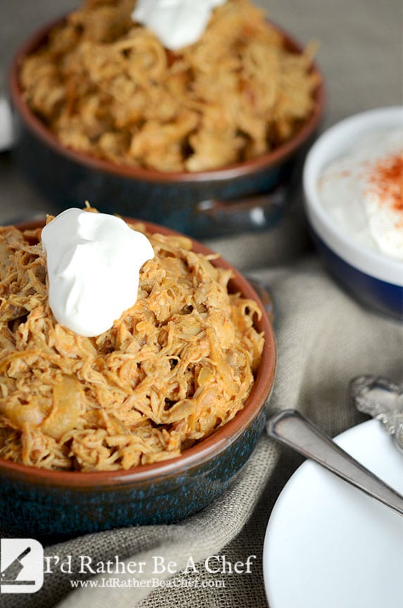 Chicken paprikash topped with sour cream served in a dish