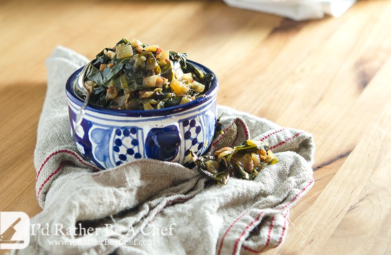 Southern collard greens served in a bowl on a kitchen towel