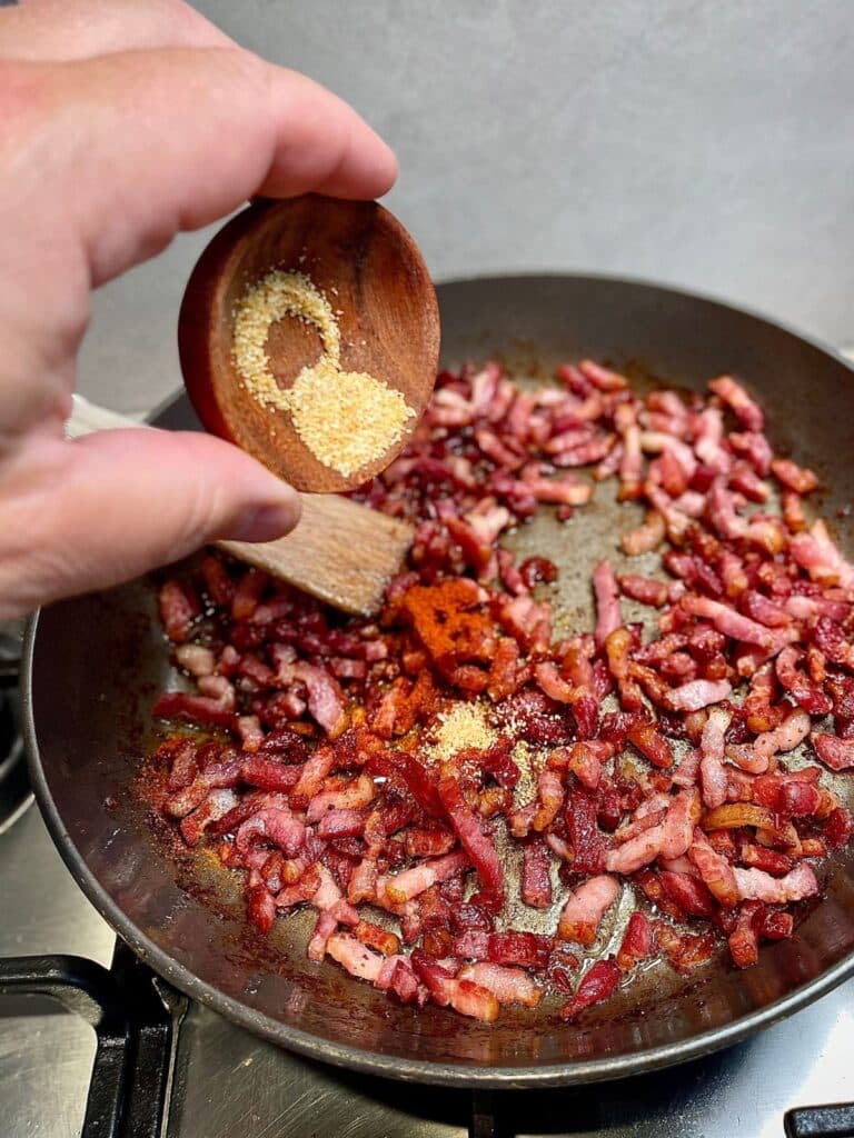 Various spices and seasonings being added to the homemade bacon bits