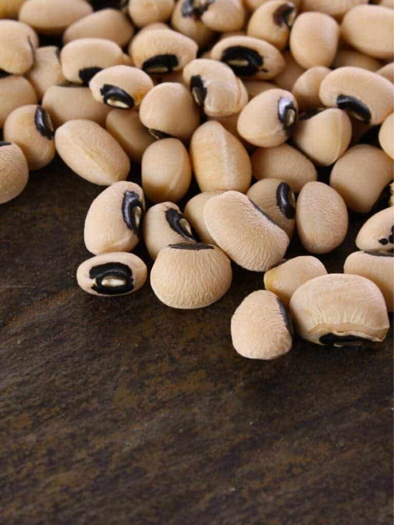 Close up of black eyed peas on a wooden surface