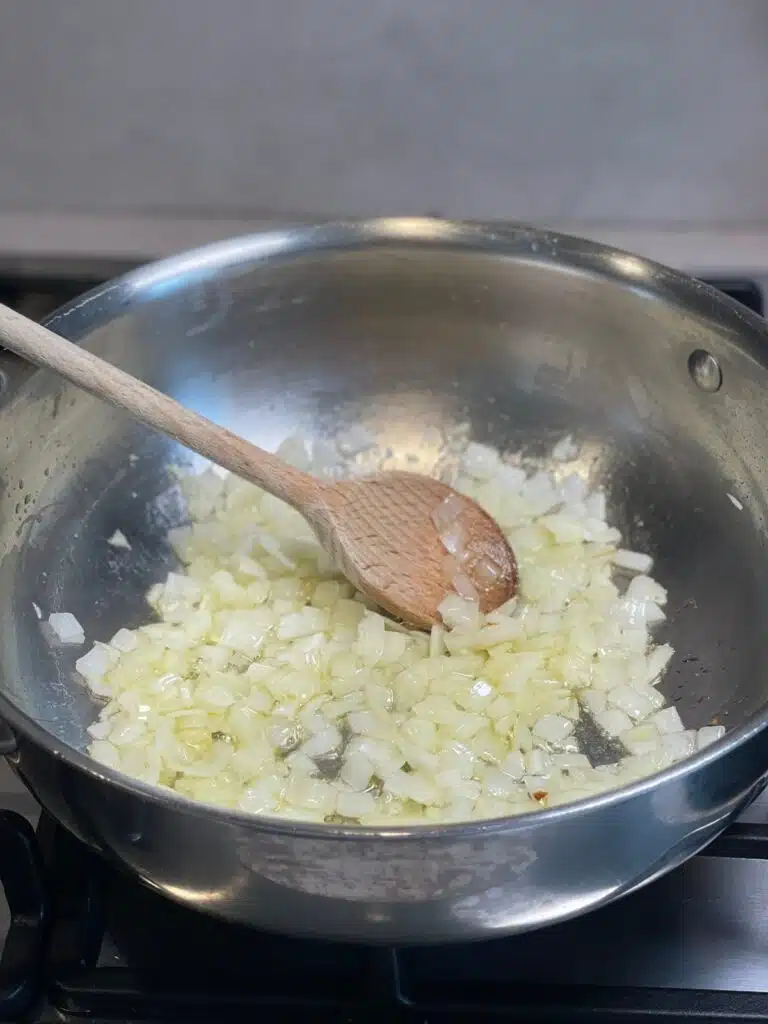 Onions simmering in a pan in preparation for homemade tomato sauce