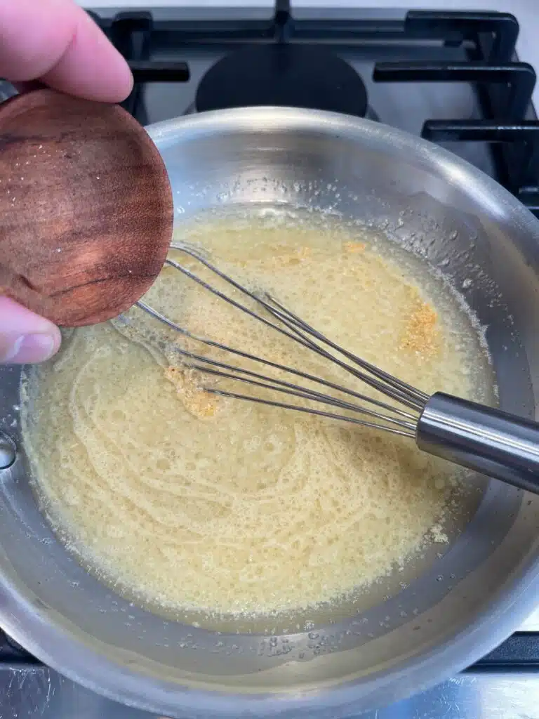 More ingredients added to the mixture for hot bacon salad dressing