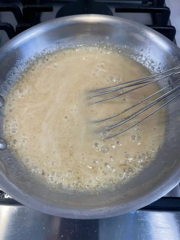 Everything mixed together in a pan to make hot bacon salad dressing