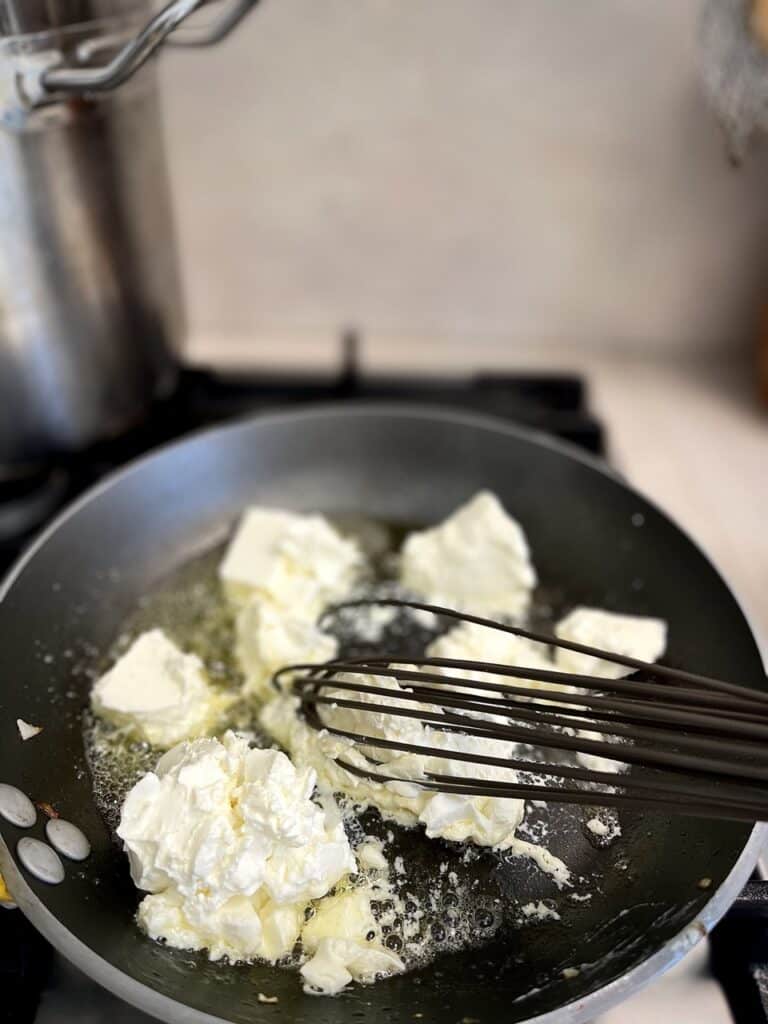 Melting cream cheese and butter in a frying pan.
