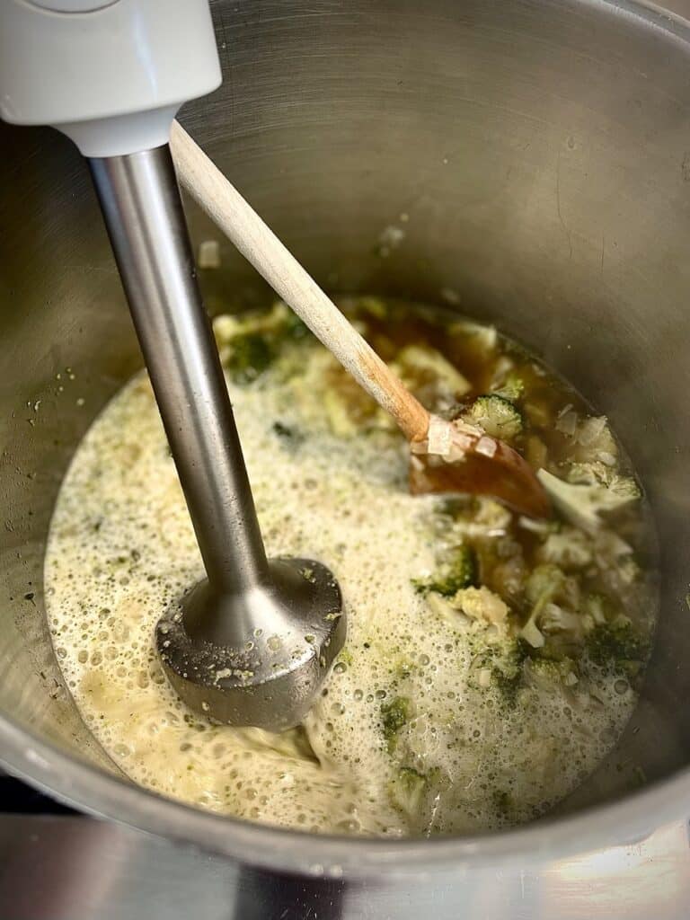 Immersion blending the broccoli and cheese mixture for the soup.