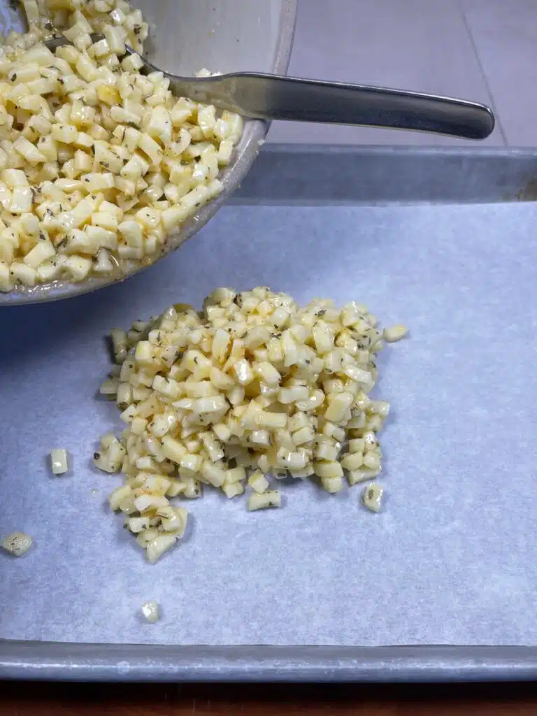 Cheese and bread mixture being laid out onto a baking sheet