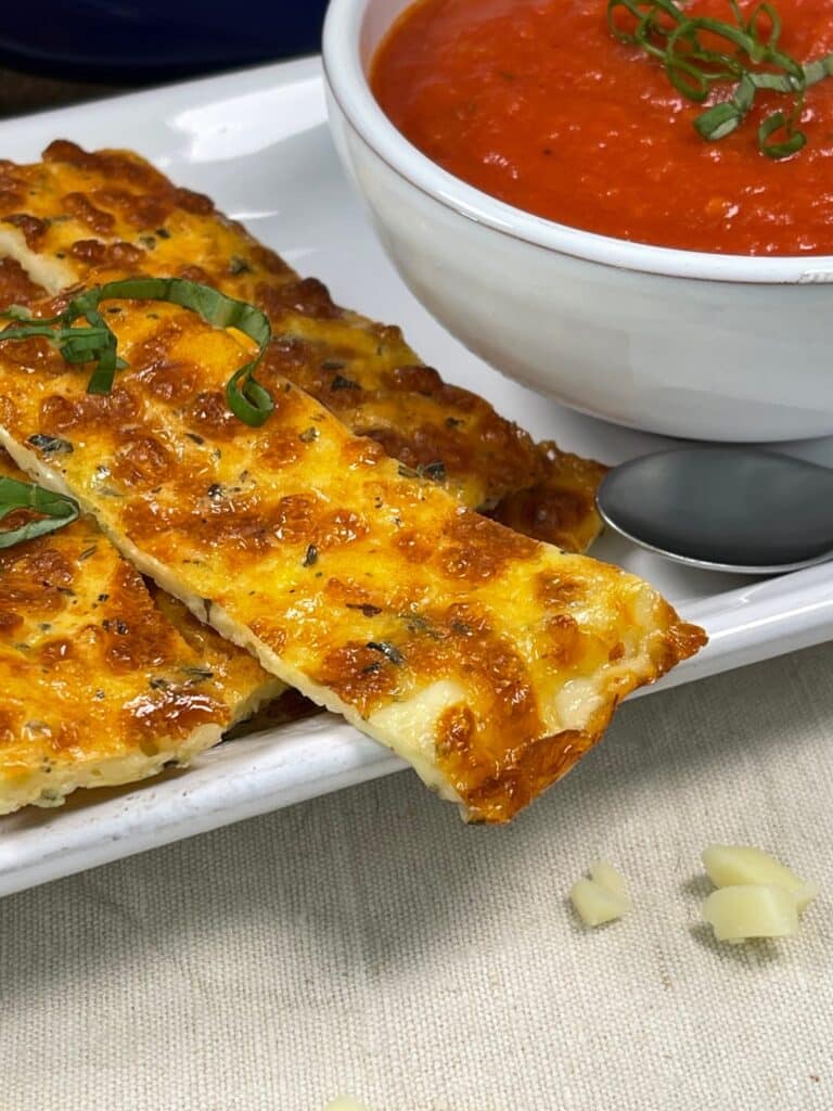 Close up of a cheesy keto breadstick on a plate