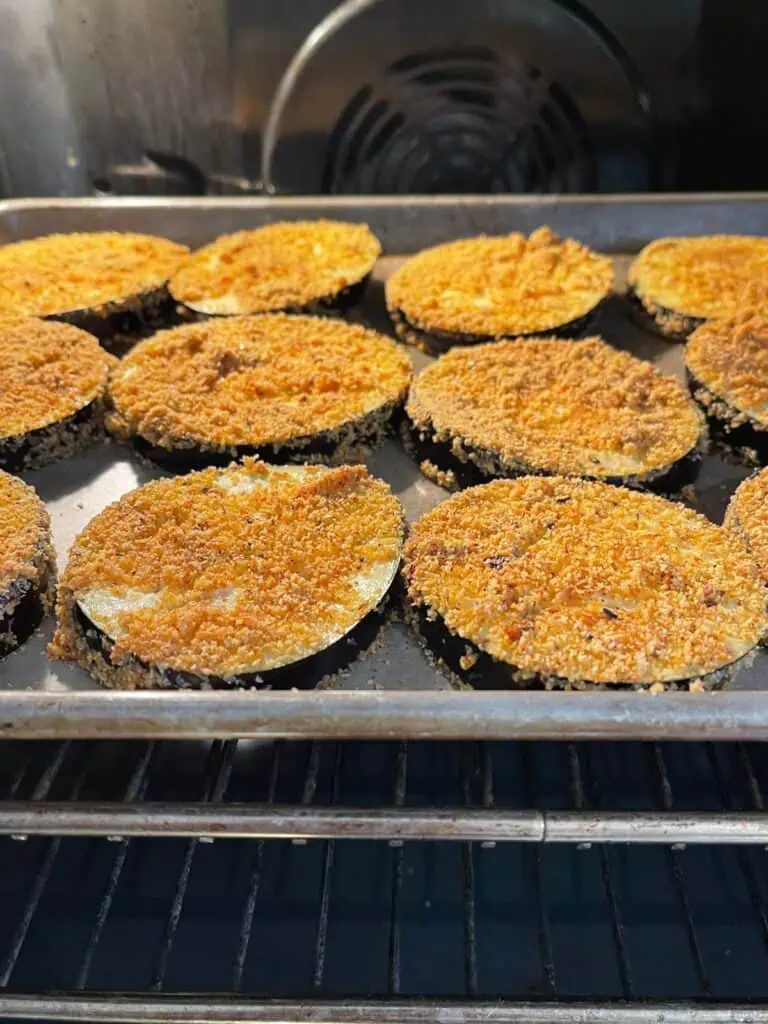 Eggplant roasting in the oven on a baking tray