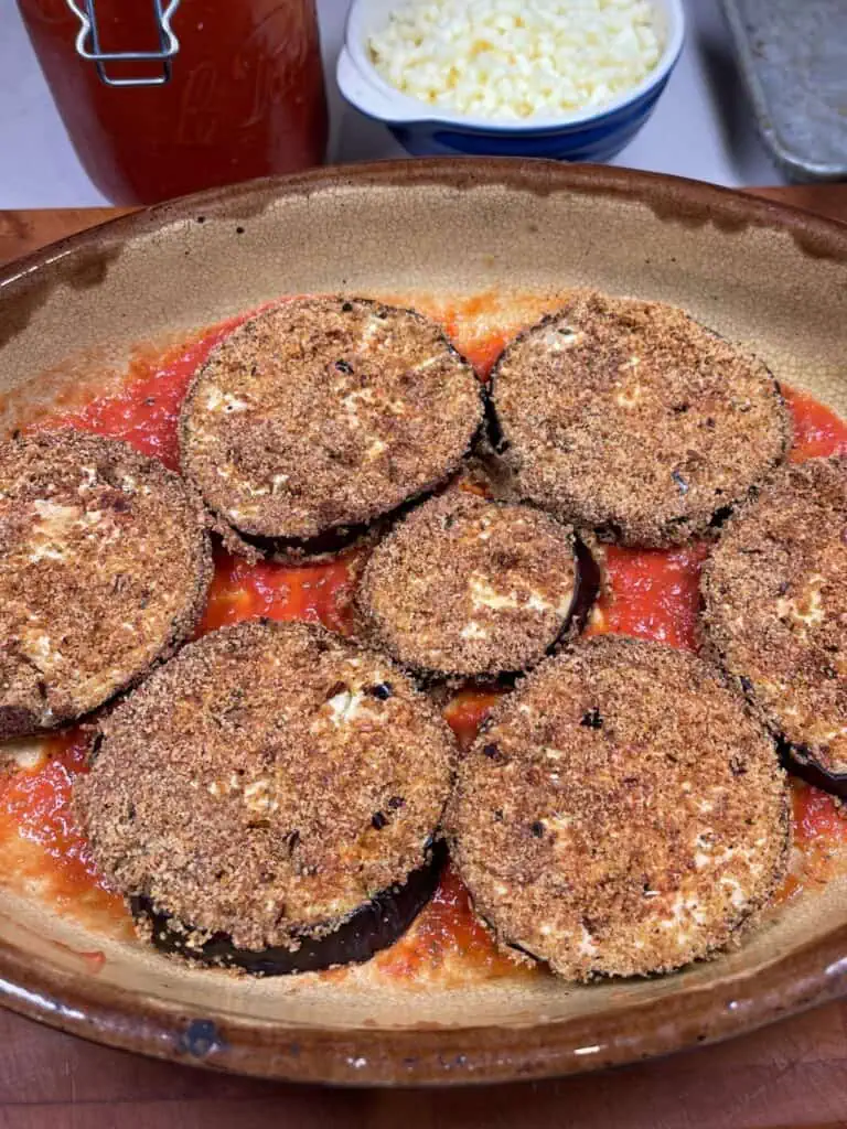 Eggplant being placed into baking dish