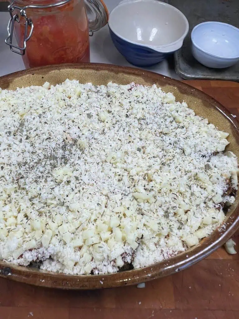 Final Layer of cheese and herbs being added