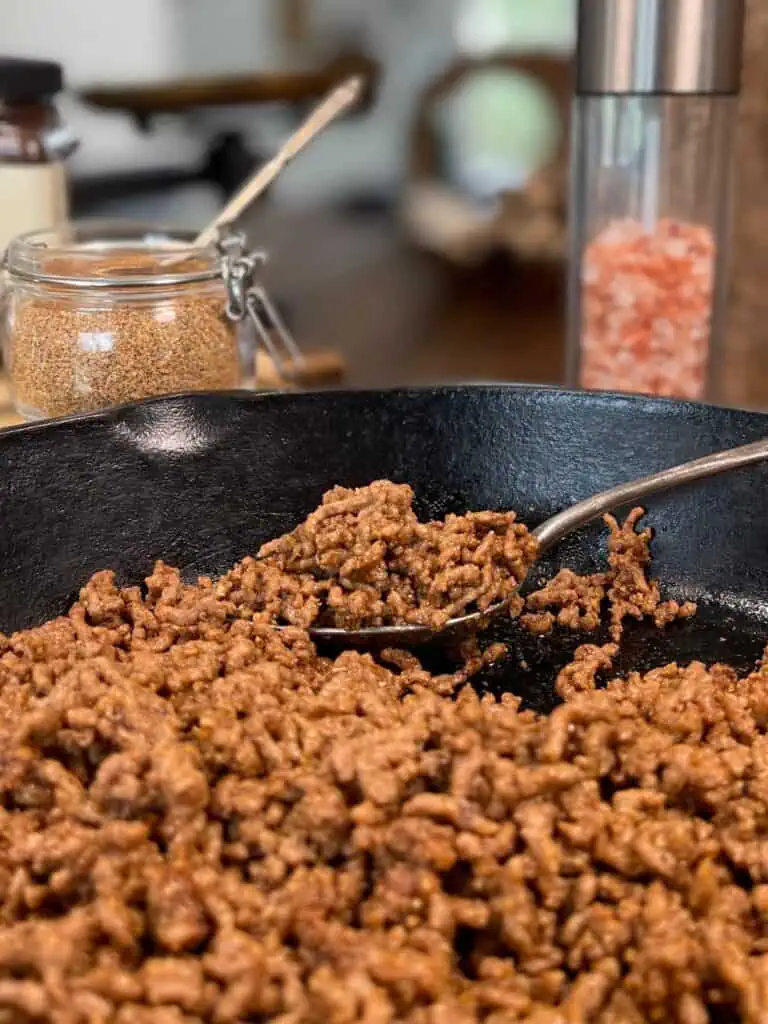 Close up of seasoned ground beef in a pan