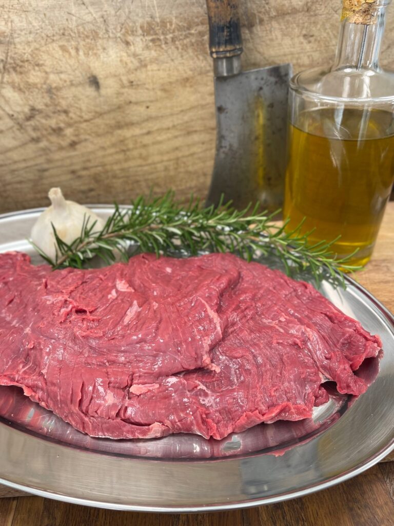 Raw steak in preparation for steak marinade