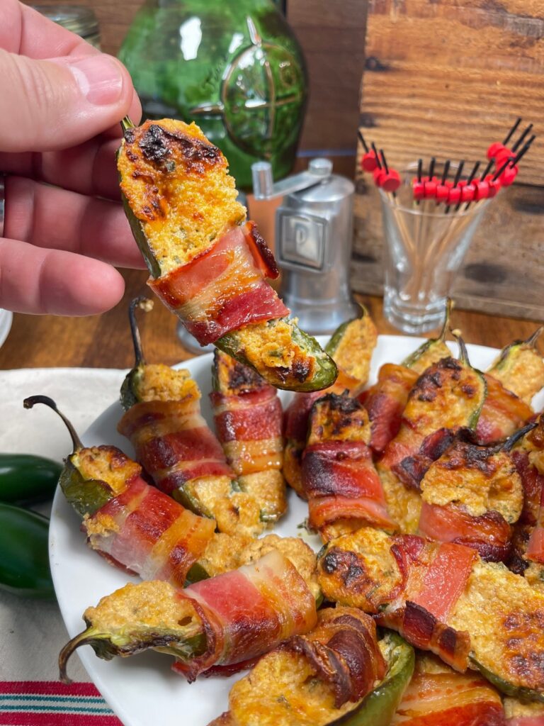 Bacon wrapped Jalapeño popper being held over others