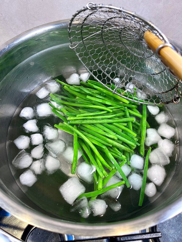 Green beans being dumped into cold water for French haricots verts