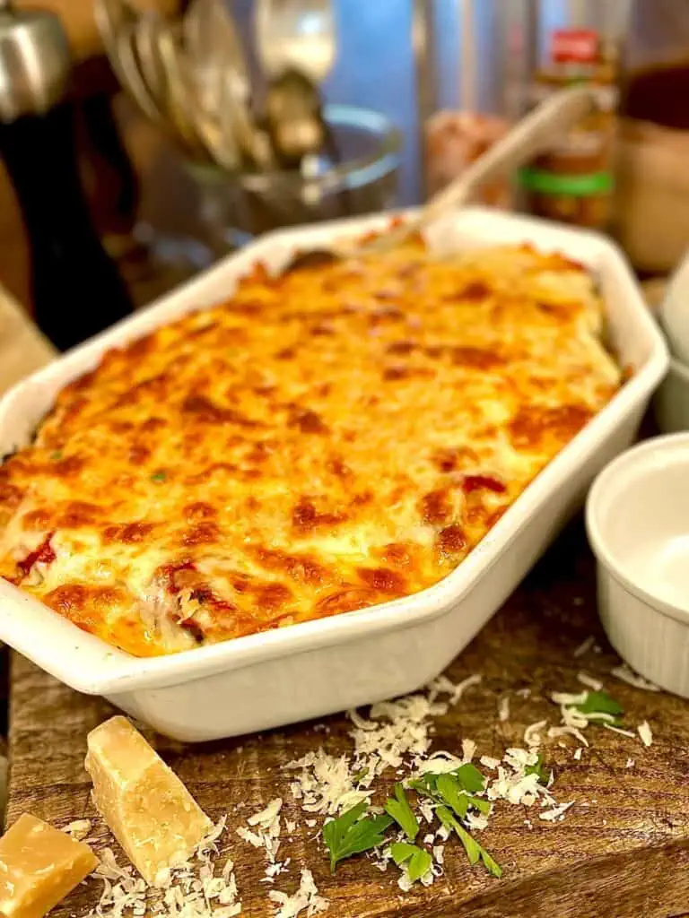 Meatball parm in baking dish presented on a cutting board