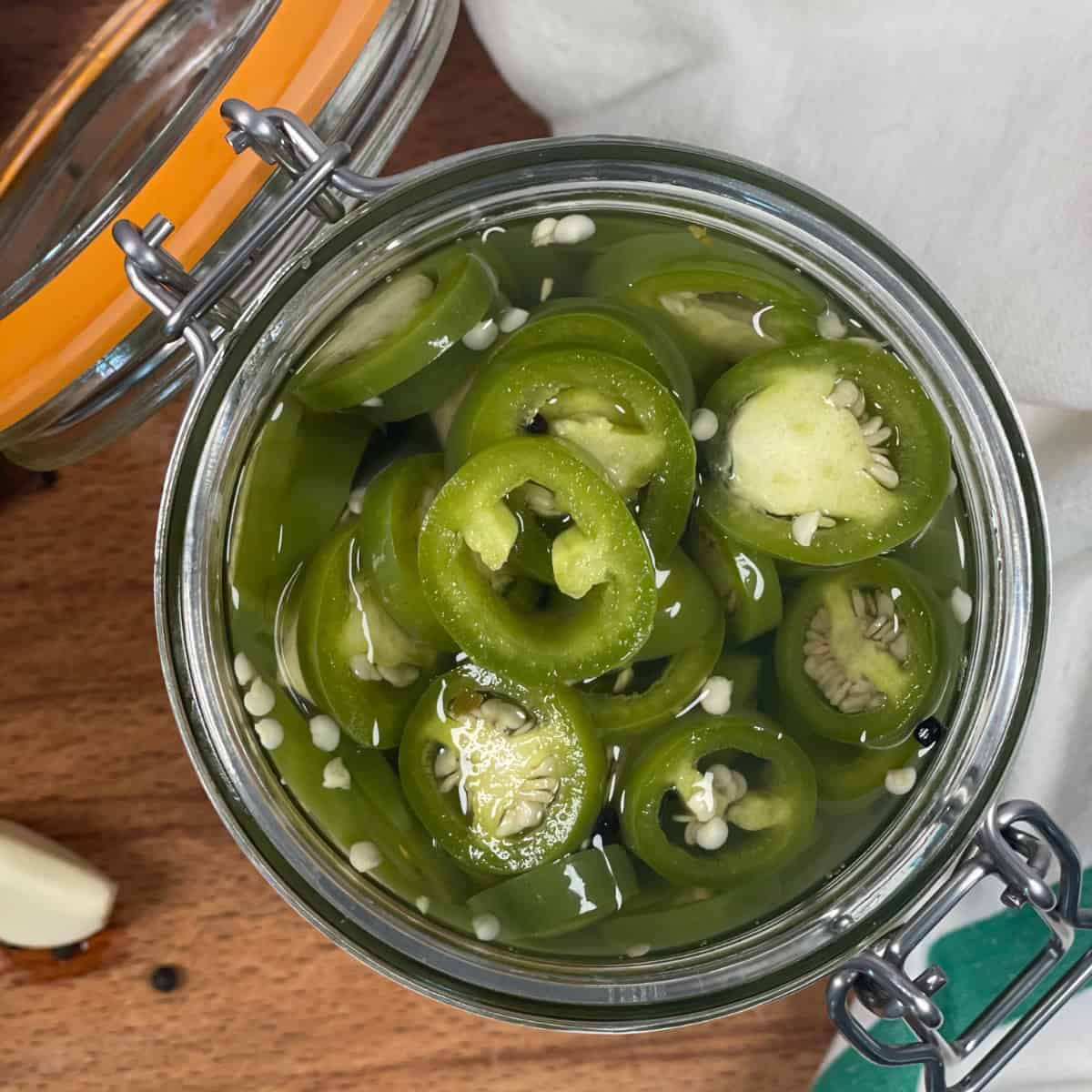 Mason jar of pickled jalapeño peppers featured image